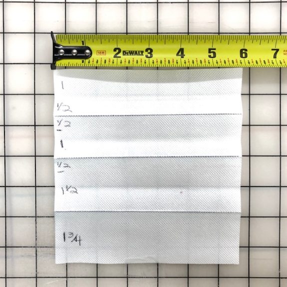 Make a tool for easily marking and folding the pleats for the face mask. I used 6" wide buckram but you can use paper. Fold it into sections as shown on this template.